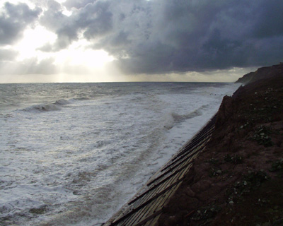High tide reaches the revetment at Trimingham